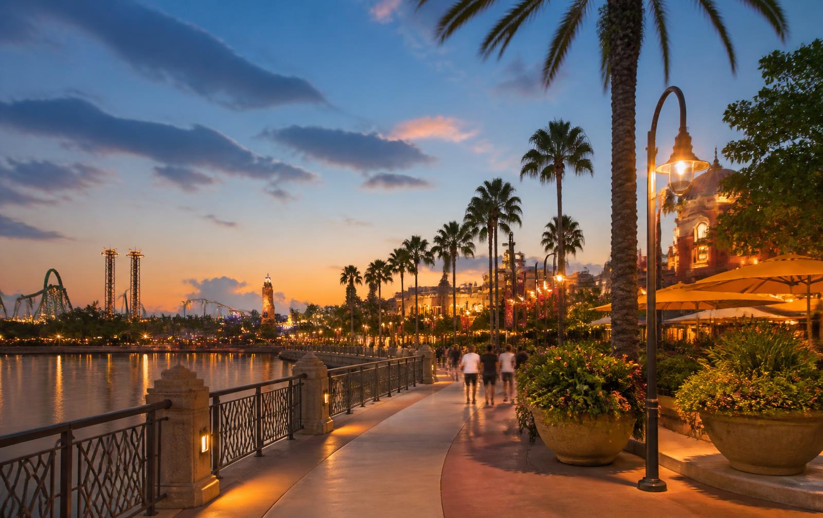 Palm-lined promenade at an Orlando resort area at dusk