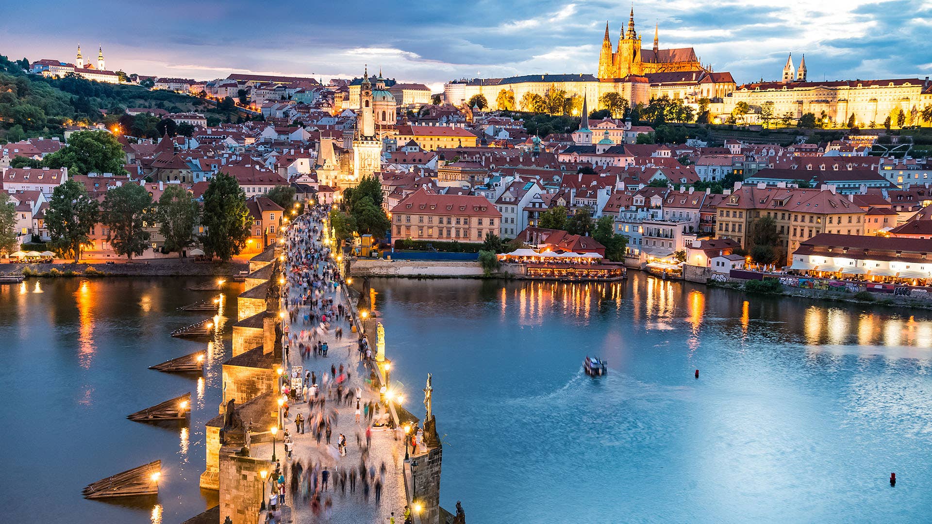Prague Castle and Charles Bridge above the Vltava at dusk